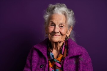 Canvas Print - Close-up portrait photography of a tender old woman wearing a chic cardigan against a vibrant purple background. With generative AI technology