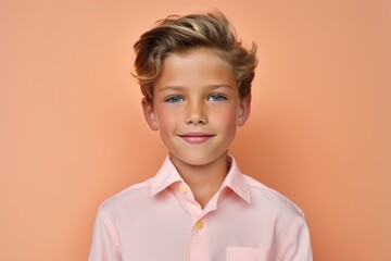 Canvas Print - Close-up portrait photography of a beautiful kid male wearing a casual short-sleeve shirt against a peachy pink background. With generative AI technology