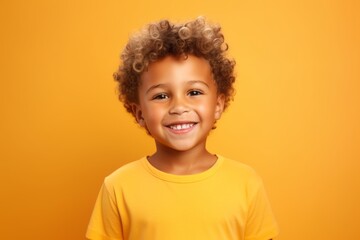 Wall Mural - Close-up portrait photography of a glad kid male wearing a casual t-shirt against a bright yellow background. With generative AI technology
