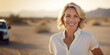 © Kalim - AI generated image of happy mature senior woman on beach or desert