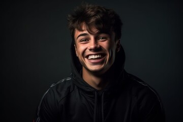 Wall Mural - Medium shot portrait photography of a joyful boy in his 20s wearing a comfortable tracksuit against a dark grey background. With generative AI technology