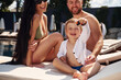 © standret - Happy family of father, mother and son are in the pool