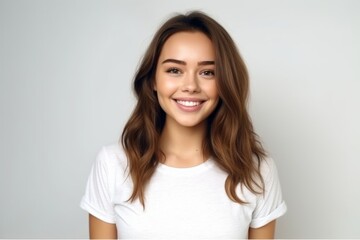 Wall Mural - Medium shot portrait photography of a glad girl in her 20s wearing a casual t-shirt against a pearl white background. With generative AI technology