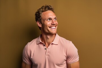 Poster - Lifestyle portrait photography of a satisfied boy in his 30s wearing a sporty polo shirt against a warm taupe background. With generative AI technology