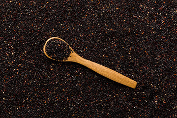 black quinoa grain in wooden spoon background and texture of gluten free top view