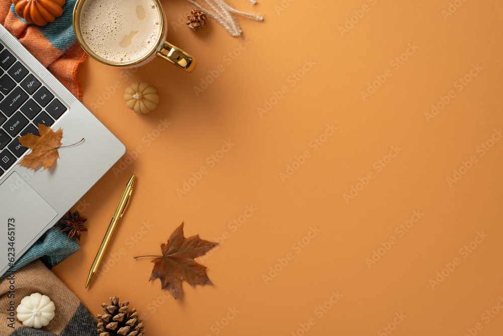 Freelance work in autumn concept. Top view photo of laptop, pen, a cup of coffee, patchy scarf and decor of pumpkin candles, maple leaves and pinecones on brown isolated background with copy-space