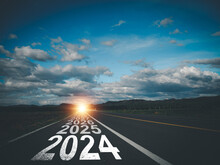 New Year Direction Concept And Sustainable Development Concept On The Road Labeled 2024 To 2030 At Sunset In The Evening At The Destination