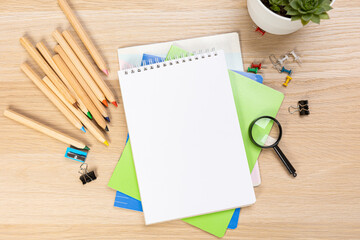 Wall Mural - Notebook mockup with school stationery on a wooden table. back to school concept. Blank notepad with copy space. list of goals and plans for new year 2023