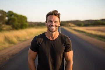 Wall Mural - Three-quarter studio portrait photography of a happy boy in his 30s wearing a casual t-shirt against a winding country road background. With generative AI technology