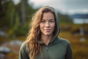 Wall Mural - Headshot portrait photography of a glad girl in her 30s wearing a stylish hoodie against a national park background. With generative AI technology