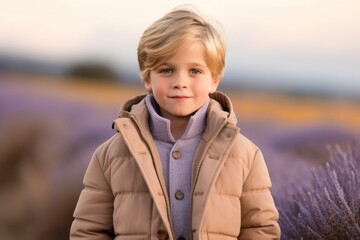 Wall Mural - Three-quarter studio portrait photography of a glad kid male wearing a cozy winter coat against a lavender field background. With generative AI technology