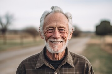 Poster - Headshot portrait photography of a tender old man wearing an elegant long-sleeve shirt against a sprawling ranch background. With generative AI technology