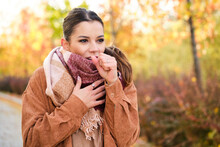 Caucasian Young Woman Coughing During Autumn.