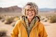 Casual fashion portrait photography of a joyful mature woman wearing a warm parka against a picturesque desert oasis background. With generative AI technology