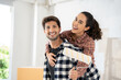 © Bavorndej - Happy Brazilian couple holding roller in hand and looking to camera at new home location. Home renovation DIY renew home concept.
