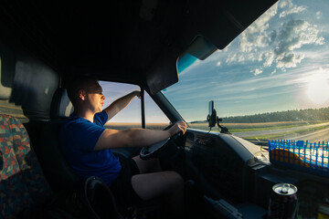 male trucker rides on a sunny day for a trip. Young van driver