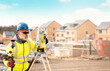 © Iryna - Surveyor builder site engineer with theodolite total station at construction site outdoors during surveying work