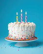 © vvalentine - White Birthday cake with colorful Sprinkles over a blue background, generative ai