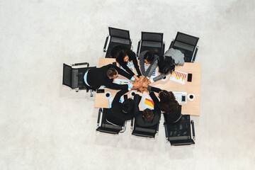 Wall Mural - Happy business people celebrate teamwork success together with joy at office table shot from top view . Young businessman and businesswoman workers express cheerful victory show unity support . Jivy