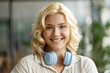 Closeup portrait of smiling cute school girl wearing wireless headphones looking at camera. Education concept 