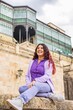 © Sangiao_Photography - Latin woman cheerful and happiness portrait in front of Casa Lis in Salamanca. Heritage tourism.