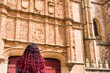 © Sangiao_Photography - Looking for the frog and skull in Salamanca university plateresque facade. Latin middle-aged woman