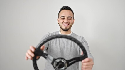 Wall Mural - Hispanic man smiling confident using steering wheel as a driver over isolated white background