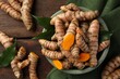 Fresh turmeric roots on wooden table, flat lay