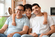© Pixel-Shot - Happy little boy with his dad and grandfather at home
