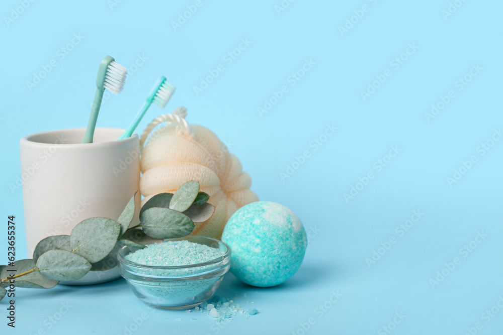 Set of bath supplies and eucalyptus branch on color background