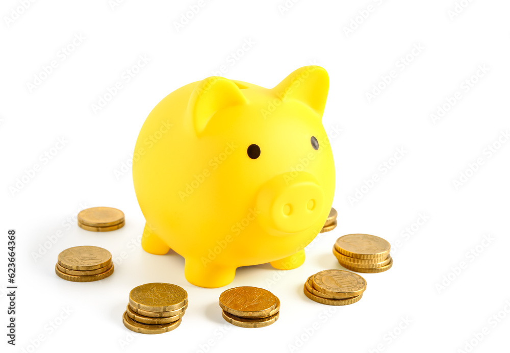 Yellow piggy bank with coins isolated on white background
