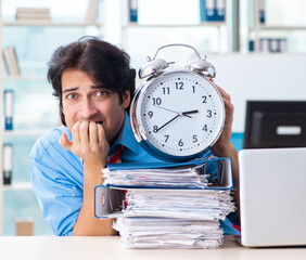 Wall Mural - Handsome businessman unhappy with excessive work in the office