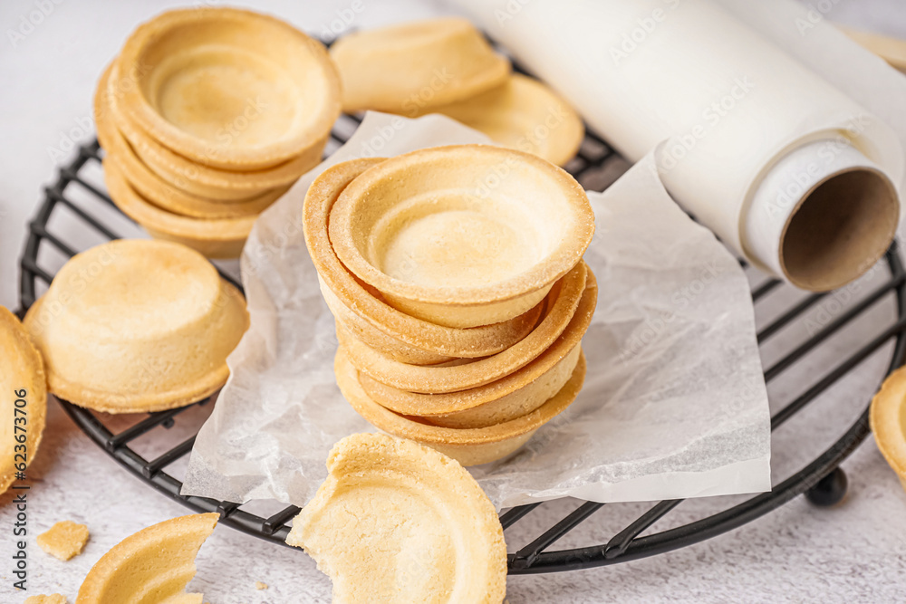 Grid with homemade tartlets on white background