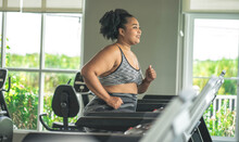 Girl Plus Size Women In Sports Bras Walking And Running On The Treadmill Weight Loss And Exercise In The Gym
