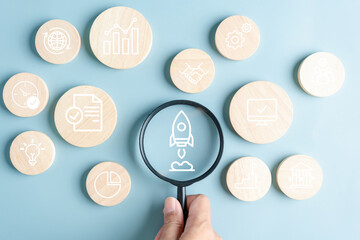 Leinwandbilder - Magnifier focus to rocket launch icon, Business hand launch investment fast track wealth or earning rising up graph increasing profit financial concept.