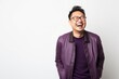 © Robert MEYNER - Portrait of a happy young asian man laughing on white background