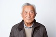 © Robert MEYNER - Portrait of senior asian man in black jacket on white background