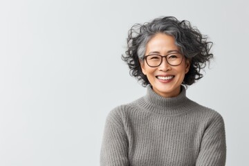 Portrait of smiling asian woman in eyeglasses looking at camera