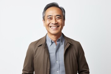 Portrait photography of a happy Indonesian man in his 50s wearing a chic cardigan against a white background 