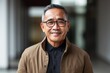Portrait photography of a satisfied Indonesian man in his 50s wearing a chic cardigan against an abstract background 