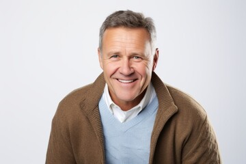 Portrait of a happy mature man smiling at the camera over white background