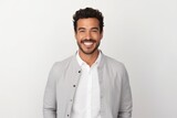 Fototapeta Do akwarium - Portrait of a handsome young man smiling at camera while standing against white background