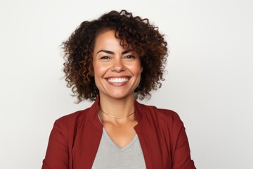 Portrait of a smiling businesswoman with curly hair against white background