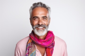 Wall Mural - Portrait of a happy mature Indian man smiling while standing against white background