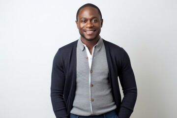 Wall Mural - Portrait of smiling african american man standing against white wall