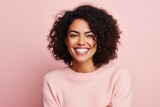 Fototapeta  - Portrait of a beautiful young african american woman smiling against pink background