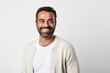 © Robert MEYNER - Portrait of a happy Indian man smiling at camera over white background