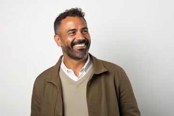 Portrait of a middle-aged Indian man smiling at the camera