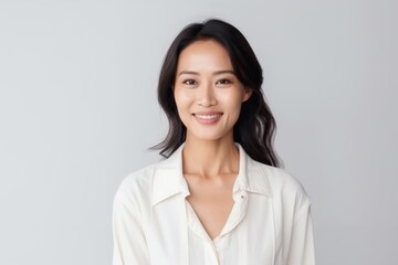 Wall Mural - Portrait of a beautiful asian woman smiling isolated on a white background