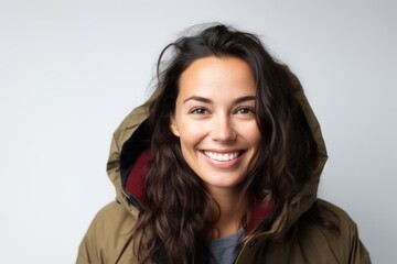 Wall Mural - Portrait of a smiling young woman in winter jacket against white background